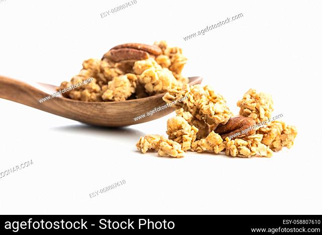 Breakfast cereal. Morning granola in wooden spoon isolated on white background