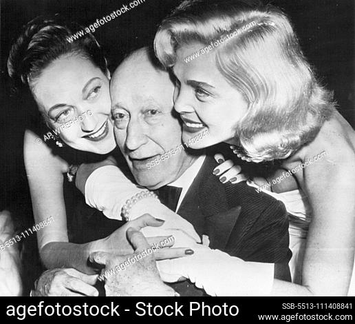 Movie Pioneer's Reward - Adolph Zukor, 80 years old yesterday and still an active leader in the film industry, gets birthday hugs from Dorothy Lamour (left) and...