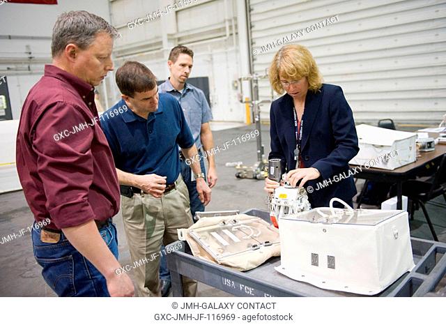 NASA astronauts Rex Walheim (second left) and Sandy Magnus, both STS-135 mission specialists, participate in an extravehicular activity (EVA) hardware training...
