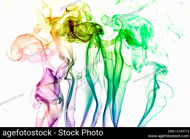 Colorful purple, blue and green smoke of incence sticks isolated at white background