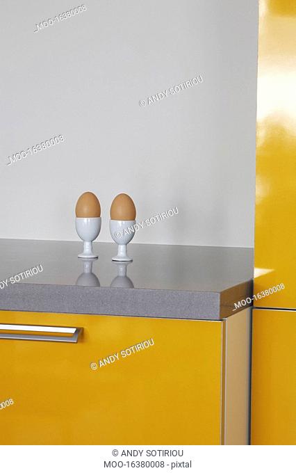 Eggs in eggcups on kitchen counter