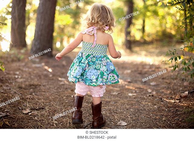 Girl walking on forest path