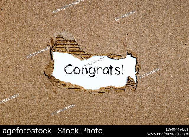 The word congrats appearing behind torn paper