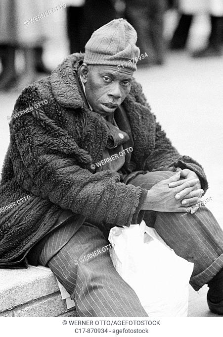 Seventies, black and white photo, people, black man wearing a fur coat and a woolly hat, aged 30 to 40 years, Great Britain, England, London