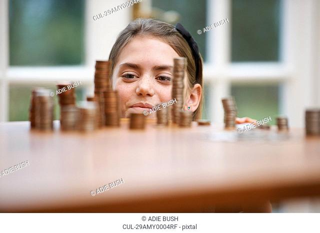 Girl looking at piles of money