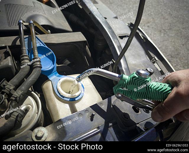 Filling water in car washer tank. Filled with water directly with a hose