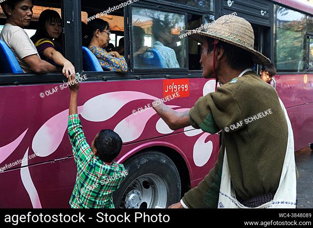 Yangon, Myanmar, Asia - A man with a missing forearm is seen begging together with his son on a street in the centre of the former capital city Rangoon hoping...
