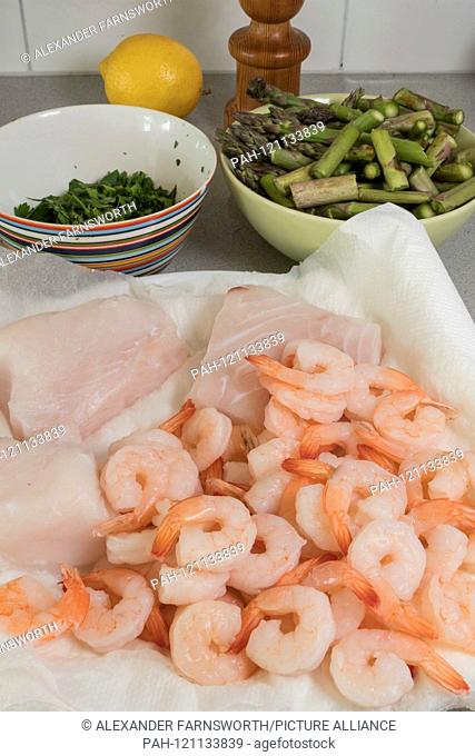 Stockholm, Sweden Dinner preparations with cod fish, shrimp and asparagus. - 2019 | usage worldwide. - STOCKHOLM/Sweden