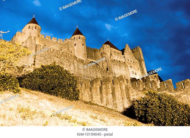 France, Languedoc, Carcassonne, Castle walls illuminated at night