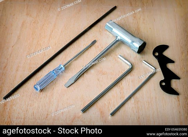 On the wooden table there are locksmith tools for work