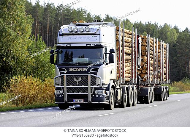 SALO, FINLAND - SEPTEMBER 21, 2018: Scania logging truck of Mauri Virtanen Oy transports load of pine logs on autumnal highway in South of Finland