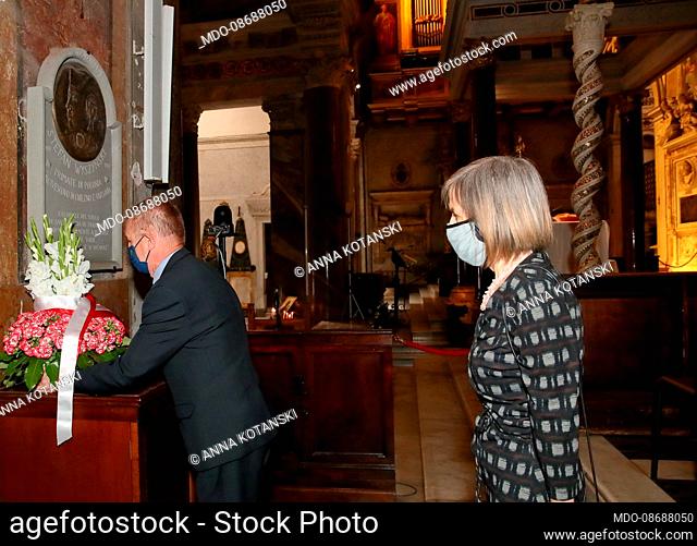 The Polish Ambassador to the Holy See Janusz Kota?ski and his wife Anna pray and offer a bouquet of flowers in front of the commemorative plaque of Cardinal...