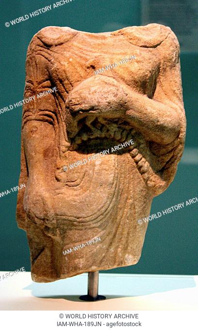 Kore (girl) holding a bead as an offering Marble, made in Ionia. From Theangela, Karia, made about 525-500BC. In Archaic Greek art the successful treatment of...