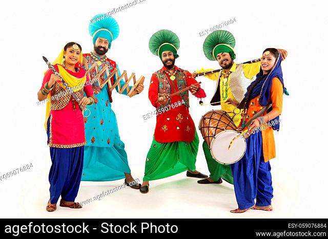 A Troupe of Punjabi Folk dancers dressed in costume with Dhol, Khunda, Alghoza, Saap and Chimta