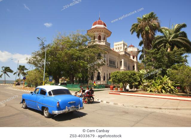 View of Valle's Palace-Palacio Valle at Punta Gorda district with an old American car in the foreground, Cienfuegos, Cuba, Central America