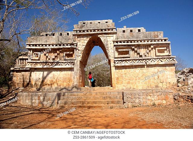 Visitors passing through the Labna Arch in the Labna Archaeological site, Puuc Route, Merida, Yucatan State, Mexico, Central America
