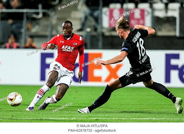 Ridgeciano Haps from Alkmaar (l) and Jan Callsen-Bracker from Augsburg (r) fight for the ball during the UEFA Europa League Group L soccer match between AZ...