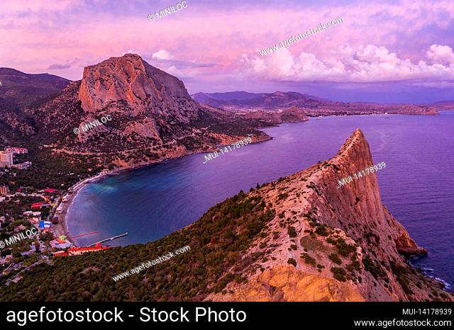 Pink sunset in Novyi Svit in autumn with mount Falcon in background. Sudak, the Republic of Crimea. Aerial view