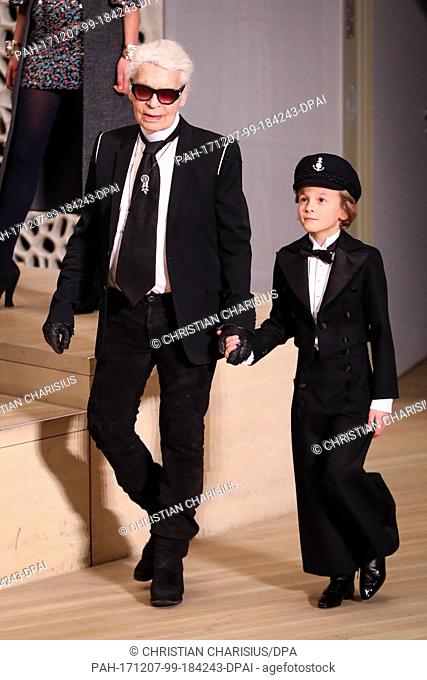 German fashion designer Karl Lagerfeld arrives holding hands with his godson Hudson Kroenig at the exclusive fashion show in the Elbe Philharmonic Hall in...