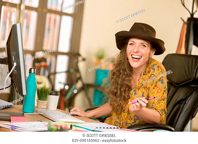 Stylish professional woman laughing in her office