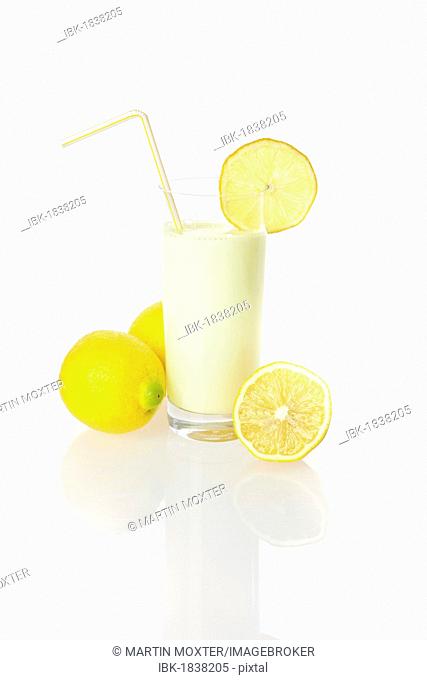 Lemon drinking yoghurt, lemon shake in a glass and lemons