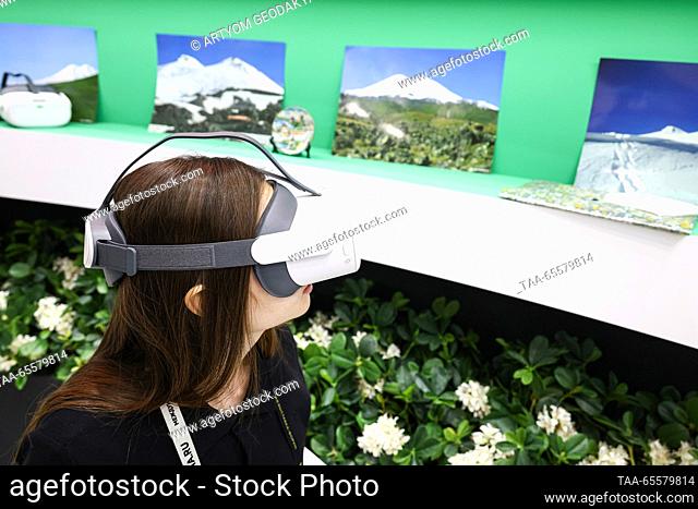 RUSSIA, MOSCOW - DECEMBER 9, 2023: A visitor uses a VR headset at a stand of the Kabardino-Balkaria Republic at the Russia Expo international exhibition and...