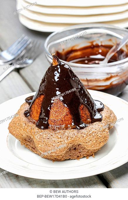 Pear in cake with chocolate sauce