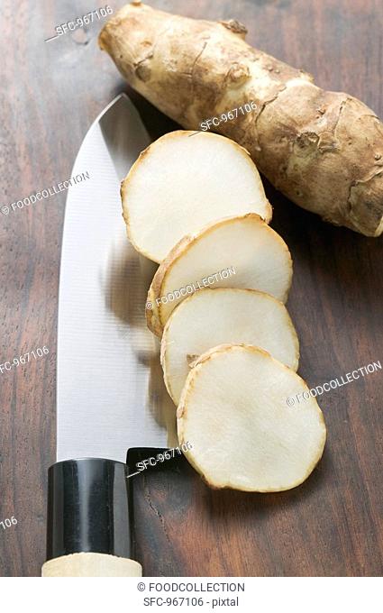 Fresh ginger root, whole and sliced