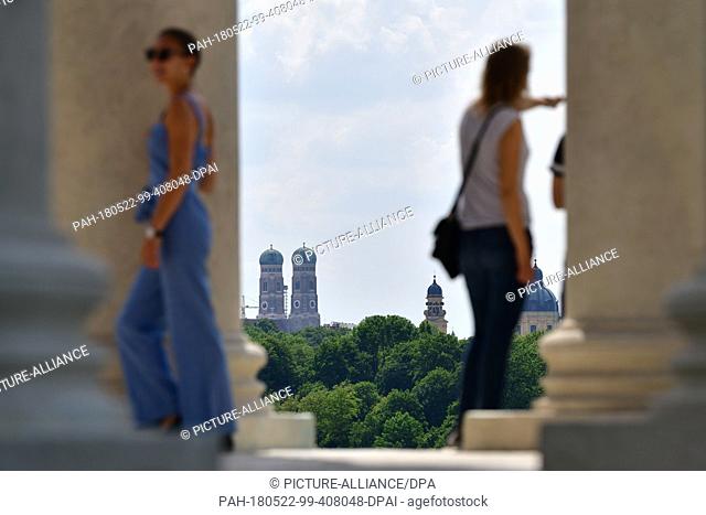 22 May 2018, Germany, Munich: The two towers of the Munich Frauenkirche (L) and the Theatine Church (R) in between the stone pillars of the Monopteros at the...