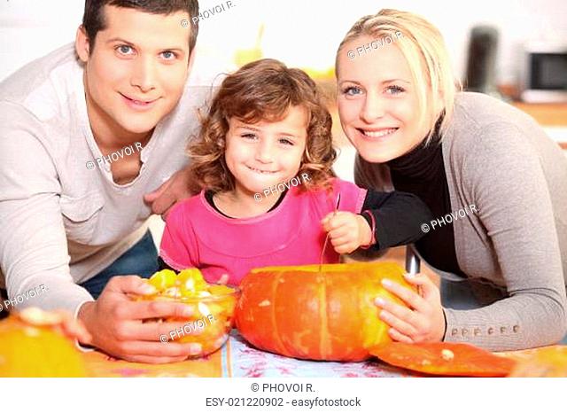A family carving a pumpkin