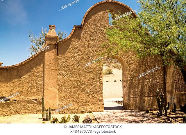 An arched wall and entry to Mission San Xavier shows the distinctice Spanish colonial influence of the architecture