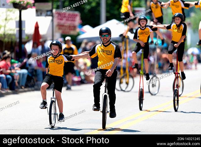 Buckhannon, West Virginia, USA - May 18, 2019: Strawberry Festival, The St. Helen Unicycle Drill Team, riding Unicycles down the street during the parade