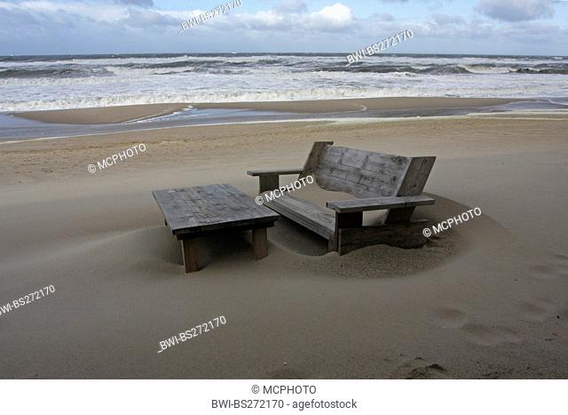 wooden bench and table at the sand beach in front of stormy sea, Germany, Schleswig-Holstein, Sylt