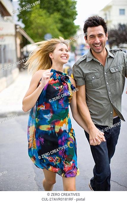 Couple running through the streets
