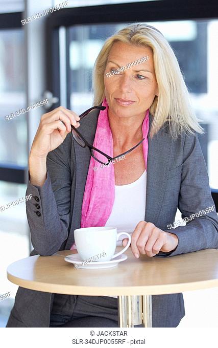 Businesswoman having cup of coffee