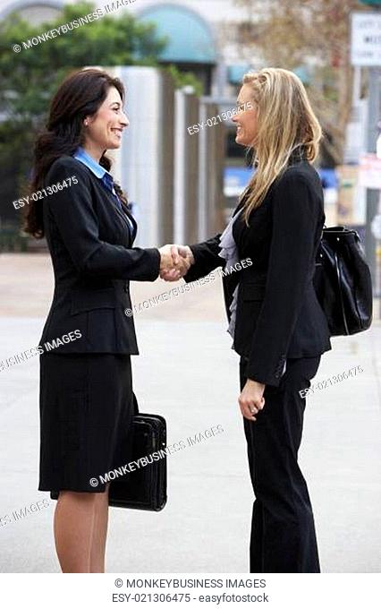 Two Businesswomen Shaking Hands Outside Office