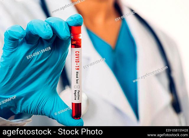 Doctor scientist in white uniform wear a mask holding test tube Coronavirus test blood sample in a clinical laboratory for analyzing isolated on white