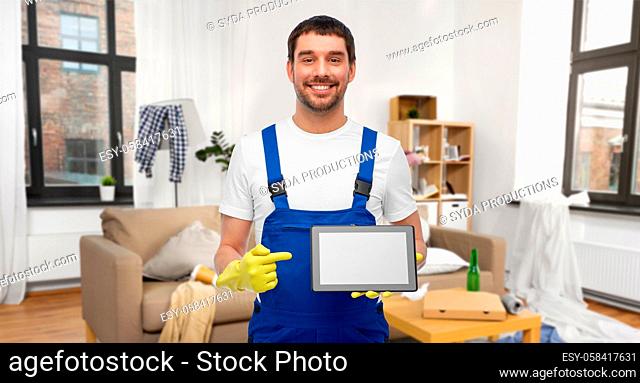 male worker or cleaner showing tablet pc at home