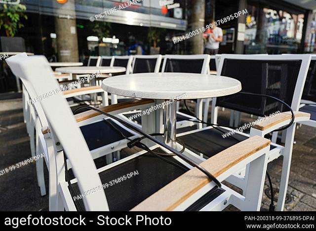 18 March 2020, Baden-Wuerttemberg, Mannheim: Empty tables stand in the morning in front of a cafe in the city centre. Photo: Uwe Anspach/dpa