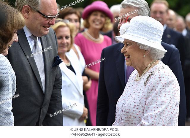 Britain's Queen Elizabeth II chats with guests at the Queen's Birthday Party at the residence of the British Ambassador to Germany in Berlin, Germany