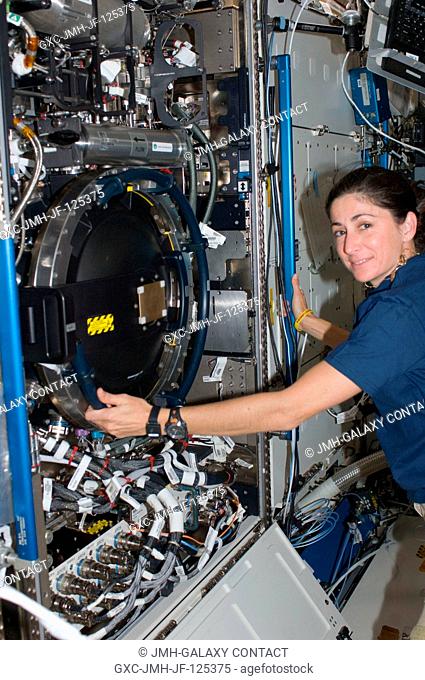 NASA astronaut Nicole Stott, Expedition 20 flight engineer, works with the Combustion Integrated Rack (CIR) in the Destiny laboratory of the International Space...