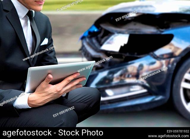 Insurance Agent Or Investigator. Car Accident Claim Report On Tablet