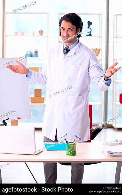 Young handsome doctor in front of whiteboard
