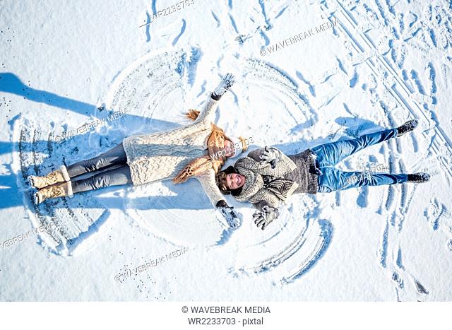 Couple doing snow angel
