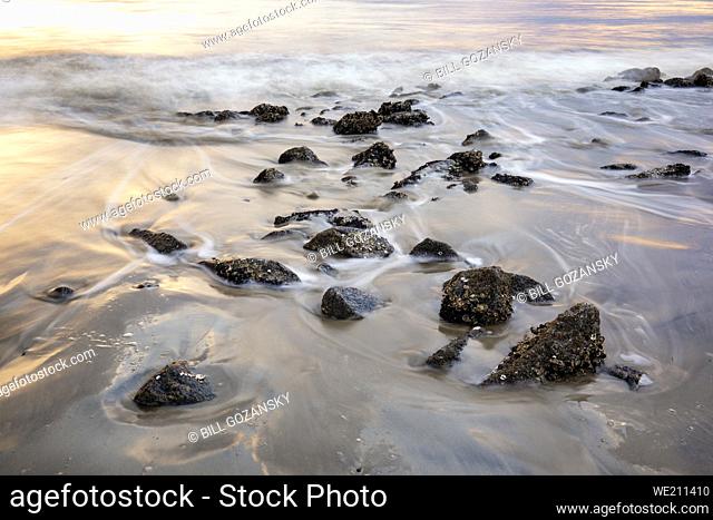 Long exposure of water and rocks on Driftwood Beach - Jekyll Island, Georgia, USA