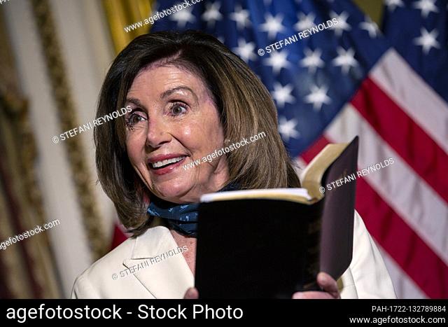 Speaker of the United States House of Representatives Nancy Pelosi (Democrat of California) reads an excerpt from the Bible following a bill enrollment ceremony...