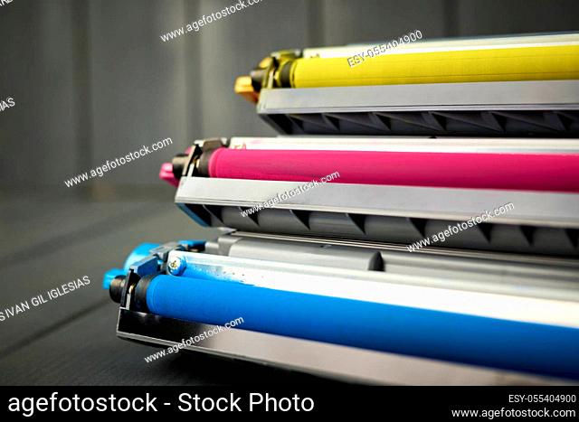 Toner replacement for cyan, magenta and yellow color laser printer on gray wooden background