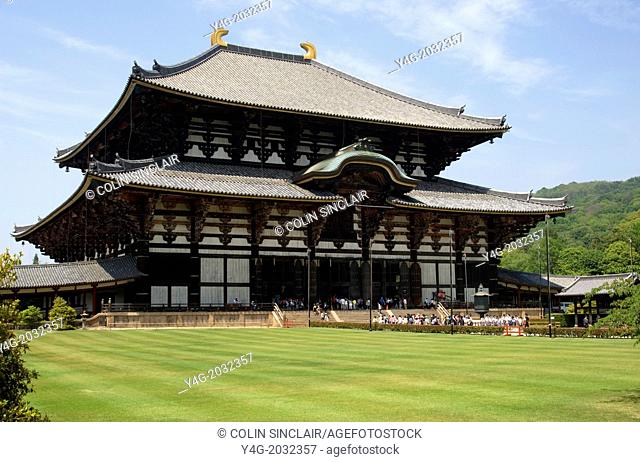 Todaiji Temple, Nara, Japan, Largest wooden structure in the World seen across an impeccable lawn with in mid distance parties of schoolchildren and tourists...