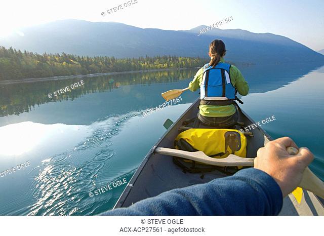 Paddling a canoe on an autumn morning on Chilko Lake, British Columbia