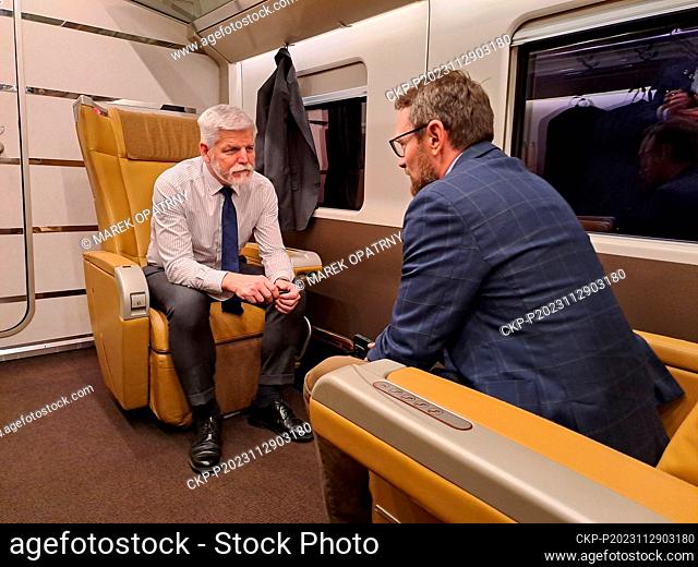 Czech President Petr Pavel, left, sits on a train on his way from Rome to Milan, Italy November 29, 2023. Petr Pavel ends his three-day visit to Italy